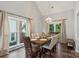 Well-lit dining room features a large window, hardwood floors, and flows into the living area at 8605 Tamarron Dr, Charlotte, NC 28277