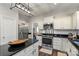 Modern kitchen with stainless steel appliances, granite countertops, and an island with a wooden bowl centerpiece at 8605 Tamarron Dr, Charlotte, NC 28277