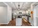 Bright kitchen features an island, stainless steel appliances, granite countertops, and wood flooring at 8605 Tamarron Dr, Charlotte, NC 28277