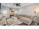 Inviting living room with brick fireplace, ceiling fan, comfortable seating, and large windows at 8605 Tamarron Dr, Charlotte, NC 28277