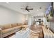 Open-concept living room flows into the kitchen, complete with a ceiling fan, sectional couch, and a media center at 8605 Tamarron Dr, Charlotte, NC 28277