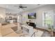 Well-lit living area with comfortable seating, an entertainment center, and view into kitchen at 8605 Tamarron Dr, Charlotte, NC 28277