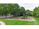 Neighborhood playground with swings, slide, and benches surrounded by trees and green grass at 8605 Tamarron Dr, Charlotte, NC 28277