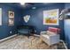 Blue Bedroom featuring a crib, comfortable chair, and a large window offering natural light at 906 Eastwood Dr, Rock Hill, SC 29730