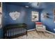 Bedroom with crib, rocking chair, and windows providing ample natural light at 906 Eastwood Dr, Rock Hill, SC 29730