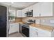 Modern kitchen with stainless steel appliances, white cabinets, and butcher block countertops at 906 Eastwood Dr, Rock Hill, SC 29730