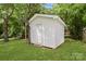 A quaint outbuilding offers extra storage space, nestled in a lush green yard with mature shade trees at 906 Eastwood Dr, Rock Hill, SC 29730