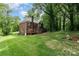 Spacious backyard featuring a wooden deck, a brick house and ample green space perfect for activities at 915 Waterview Ln, Monroe, NC 28110