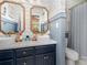 Charming bathroom with double vanity, decorative wallpaper, elegant mirrors, and stylish fixtures at 915 Waterview Ln, Monroe, NC 28110