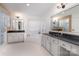 Spacious bathroom featuring white cabinets, black countertops, white tile, and modern fixtures at 915 Waterview Ln, Monroe, NC 28110