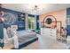 Stylish bedroom featuring a unique basketball theme, wood accent wall, modern light fixture, and natural light at 915 Waterview Ln, Monroe, NC 28110