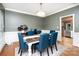 Dining room with hardwood floors, large windows, modern chandelier, and a view of the kitchen at 915 Waterview Ln, Monroe, NC 28110