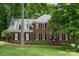 Charming two-story brick home with classic design and beautifully landscaped front yard, enhancing its curb appeal at 915 Waterview Ln, Monroe, NC 28110