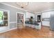 Open kitchen with an island, stainless steel appliances, a view of the living room, and hardwood floors at 915 Waterview Ln, Monroe, NC 28110