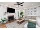 Cozy living room with a brick fireplace, comfortable seating, and natural light from the windows at 915 Waterview Ln, Monroe, NC 28110