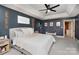 Main bedroom with tray ceiling, warm color palette, carpeted floors, and natural light at 915 Waterview Ln, Monroe, NC 28110