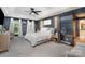 Main bedroom featuring tray ceiling, neutral color palette, and ensuite bathroom at 915 Waterview Ln, Monroe, NC 28110