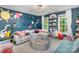 Spacious playroom featuring a large sectional sofa, ball pit, decorative wall art, and lots of natural light at 915 Waterview Ln, Monroe, NC 28110