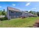 A two-story home has a cozy wood deck, surrounded by a spacious, well-manicured lawn at 9230 Loch Glen Way, Charlotte, NC 28278