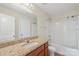 Bathroom features a granite counter and a shower-tub combo with neutral color scheme at 9230 Loch Glen Way, Charlotte, NC 28278
