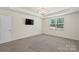 This bedroom features neutral carpet, a window to let in natural light, and TV hookups at 9230 Loch Glen Way, Charlotte, NC 28278