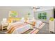 Bright bedroom showcasing two twin beds with sunny yellow accents and decor at 9230 Loch Glen Way, Charlotte, NC 28278