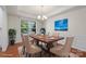 Formal dining room with a large window, wainscoting, and a wooden table for six at 9230 Loch Glen Way, Charlotte, NC 28278