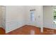 Welcoming foyer with hardwood floors, decorative trim, and a glass-paneled front door at 9230 Loch Glen Way, Charlotte, NC 28278