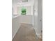Upstairs hallway with neutral carpet and a simple chandelier at 9230 Loch Glen Way, Charlotte, NC 28278
