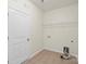 This is a simple laundry room with tiled floors and basic hookups at 9230 Loch Glen Way, Charlotte, NC 28278