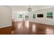 Open living room with hardwood floors, backyard access and ample natural light at 9230 Loch Glen Way, Charlotte, NC 28278