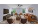 This virtually staged living room has lots of comfy leather furniture and natural light at 9230 Loch Glen Way, Charlotte, NC 28278