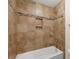 Tiled shower boasts a built-in shampoo shelf and decorative horizontal tile border at 9230 Loch Glen Way, Charlotte, NC 28278