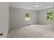 This bedroom features carpeted floors and two windows that offer natural lighting at 94 Sumner Nw Ave, Concord, NC 28027