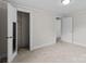 This carpeted bedroom features a closet and a white door at 94 Sumner Nw Ave, Concord, NC 28027