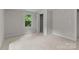 This carpeted bedroom features a closet and a window that offers natural lighting at 94 Sumner Nw Ave, Concord, NC 28027