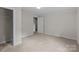 This carpeted bedroom features a closet and a white door at 94 Sumner Nw Ave, Concord, NC 28027