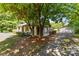 Home with a well-maintained yard, mature trees, and a detached garage, blending natural beauty with practicality at 94 Sumner Nw Ave, Concord, NC 28027
