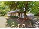 Charming home nestled among mature trees with a detached garage, blending natural beauty with practical amenities at 94 Sumner Nw Ave, Concord, NC 28027