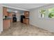 The kitchen features wooden cabinets, black appliances, and tile flooring at 94 Sumner Nw Ave, Concord, NC 28027
