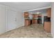 Open kitchen with wood cabinetry, black appliances, tile flooring and open layout to another room at 94 Sumner Nw Ave, Concord, NC 28027