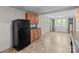 The kitchen features wooden cabinets, black appliances, and tile flooring at 94 Sumner Nw Ave, Concord, NC 28027
