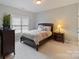 Cozy bedroom featuring neutral colors, a comfortable bed, and a window for natural light at 9433 Wallace Pond Dr, Huntersville, NC 28078