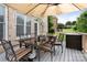 Outdoor deck features a glass table, seating, and large umbrella for shade and comfort at 9433 Wallace Pond Dr, Huntersville, NC 28078