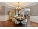 Formal dining room with hardwood floors, chandelier, and seamless flow to living area at 9433 Wallace Pond Dr, Huntersville, NC 28078