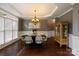 Elegant dining room featuring hardwood floors, wainscoting, and decorative chandelier at 9433 Wallace Pond Dr, Huntersville, NC 28078
