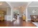 Spacious foyer with hardwood flooring, decorative columns, and staircase access at 9433 Wallace Pond Dr, Huntersville, NC 28078