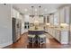 Modern kitchen featuring stainless steel appliances, a central island, and ample cabinet space at 9433 Wallace Pond Dr, Huntersville, NC 28078