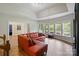 Bright living room boasts hardwood floors, recessed lighting, and a large window overlooking the backyard at 9433 Wallace Pond Dr, Huntersville, NC 28078