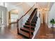 Elegant staircase with hardwood steps, iron railings, and an open floor plan at 9433 Wallace Pond Dr, Huntersville, NC 28078